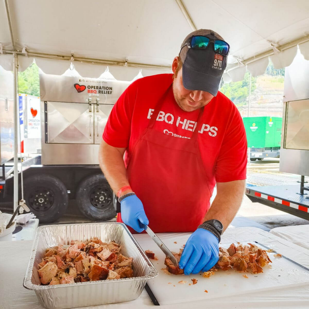 Volunteer chopping BBQ
