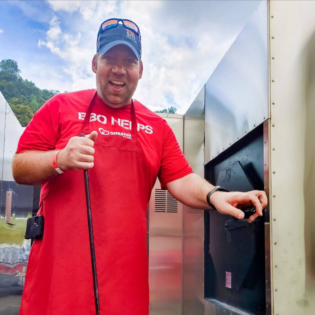 Volunteer smoking meat