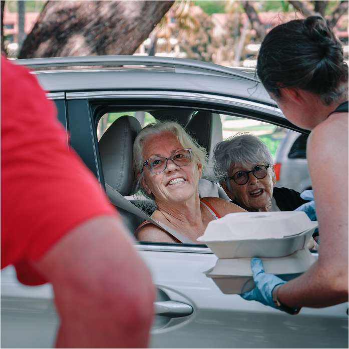 Women in car accepting food