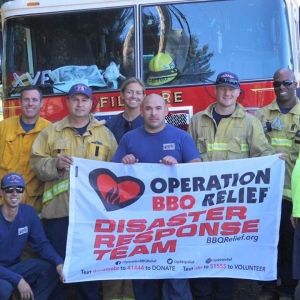 Firefighters holding sign