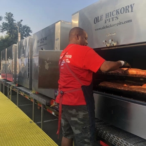 Volunteers grilling meat